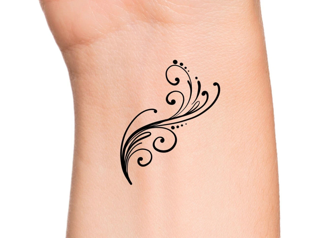 Graceful elegant swirls wrist tattoo, a sophisticated and flowing design expressing personal style for women