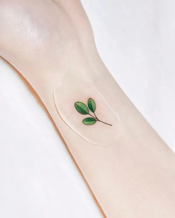 Refined elegant leaf wrist tattoo, symbolizing growth, renewal, and nature's beauty for women