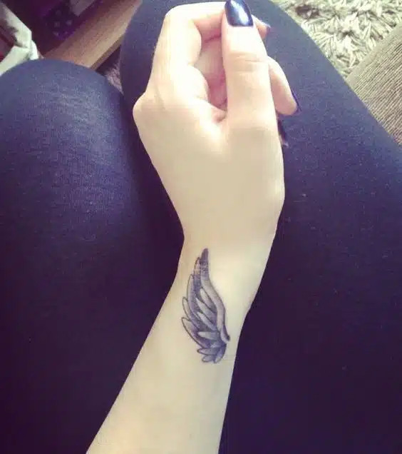 Cross wrist tattoo symbolizing faith and spiritual connection