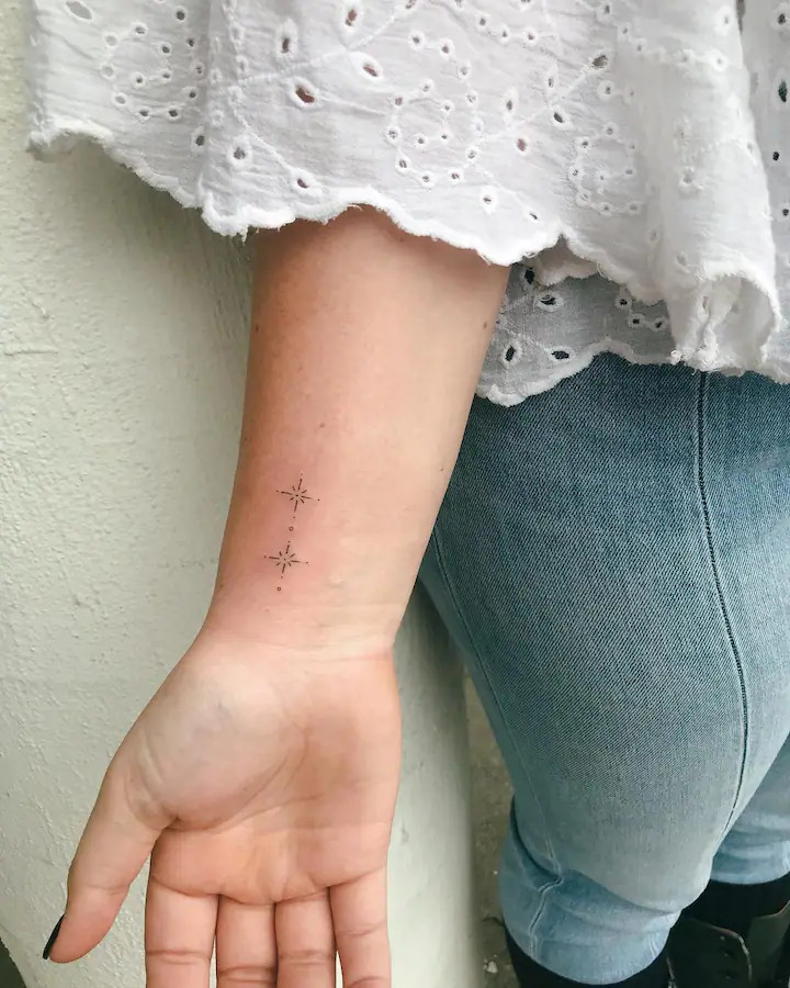 Tiny jet wrist tattoo symbolizing freedom and love for travel