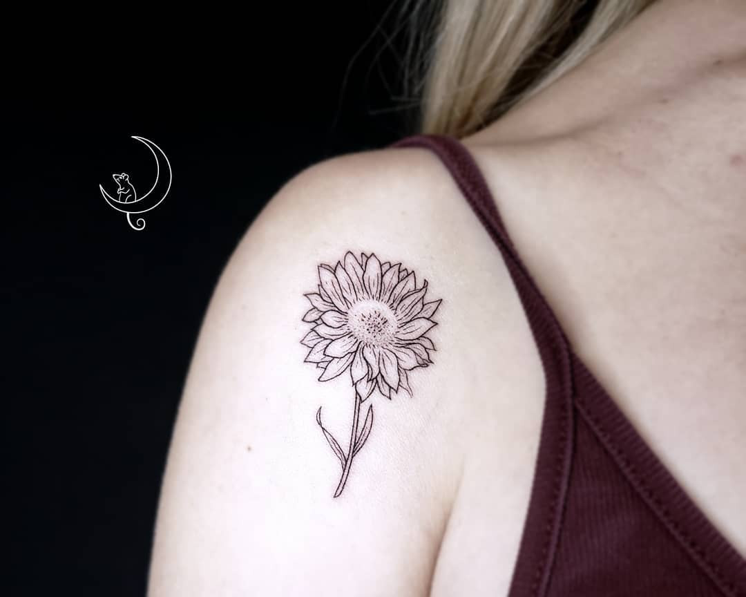 A cluster of lavender sprigs tattooed on the shoulder, representing calmness and serenity.