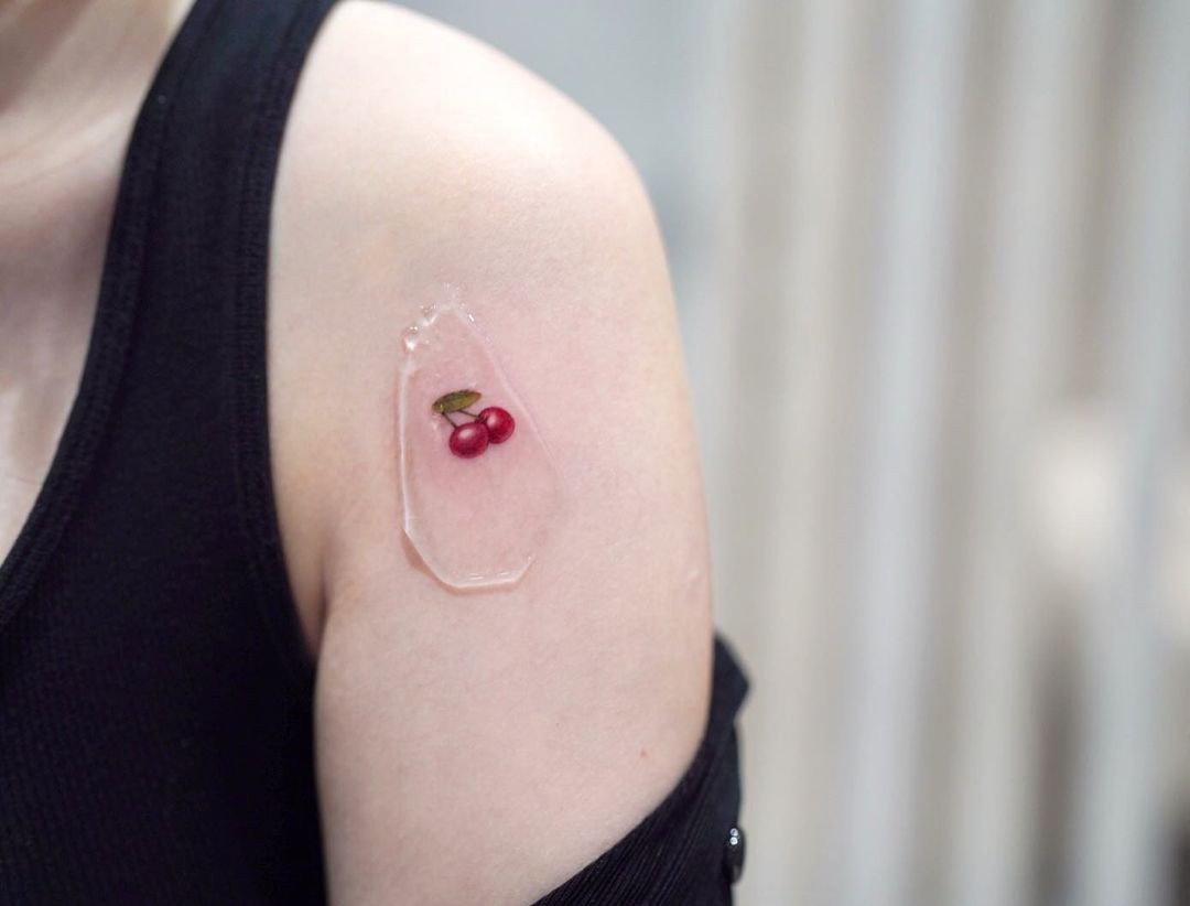 A tiny cherry tattoo on the shoulder, representing simple pleasures and delicate beauty.