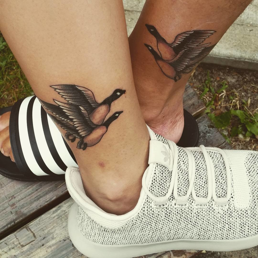 Father and daughter displaying ankle tattoos of goose designs, a lighthearted and cute option for a fun-loving father-daughter duo.