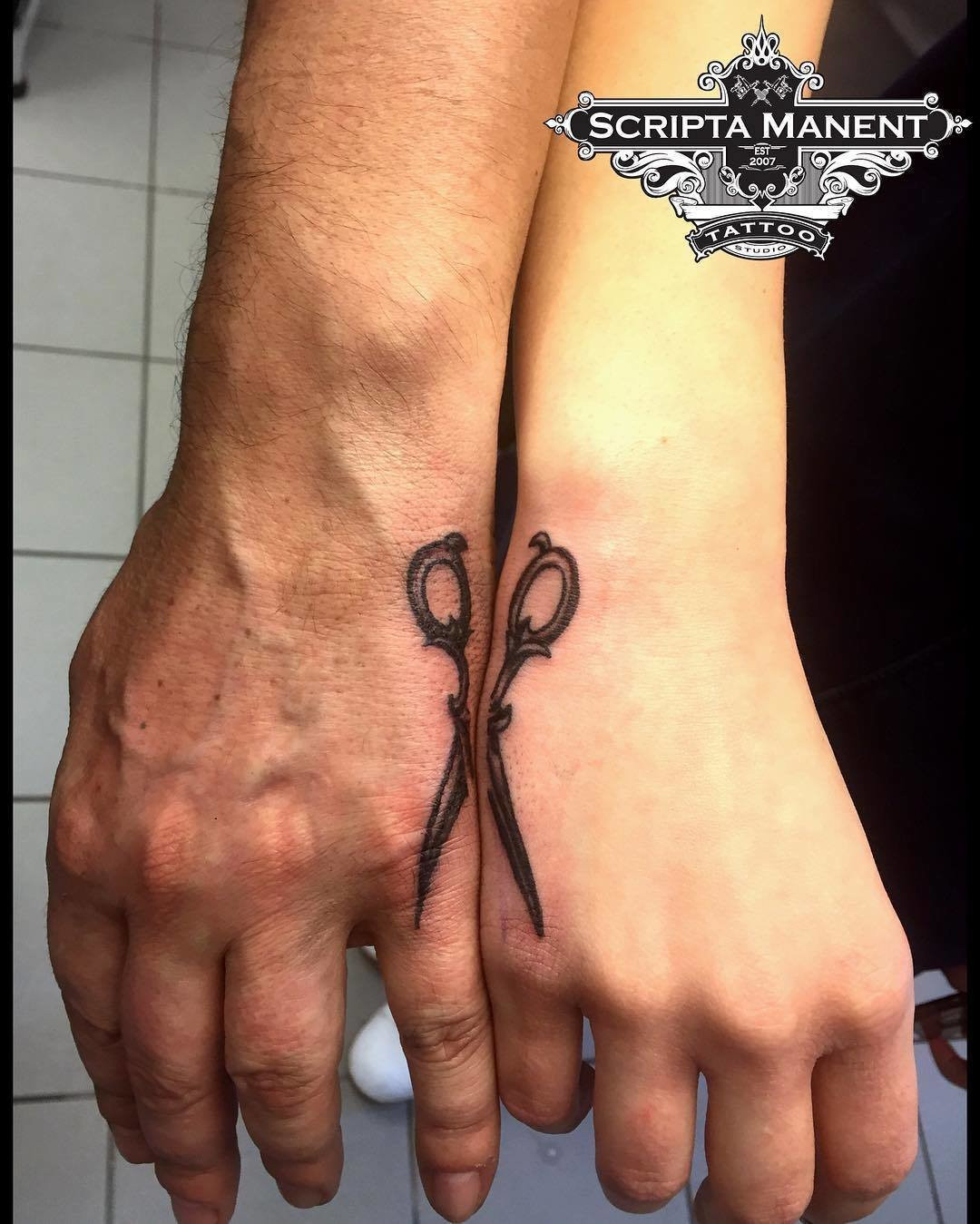 Father and daughter showcasing forearm tattoos of scissor designs, connecting to form a complete pair, symbolizing working together and being two parts of a whole.