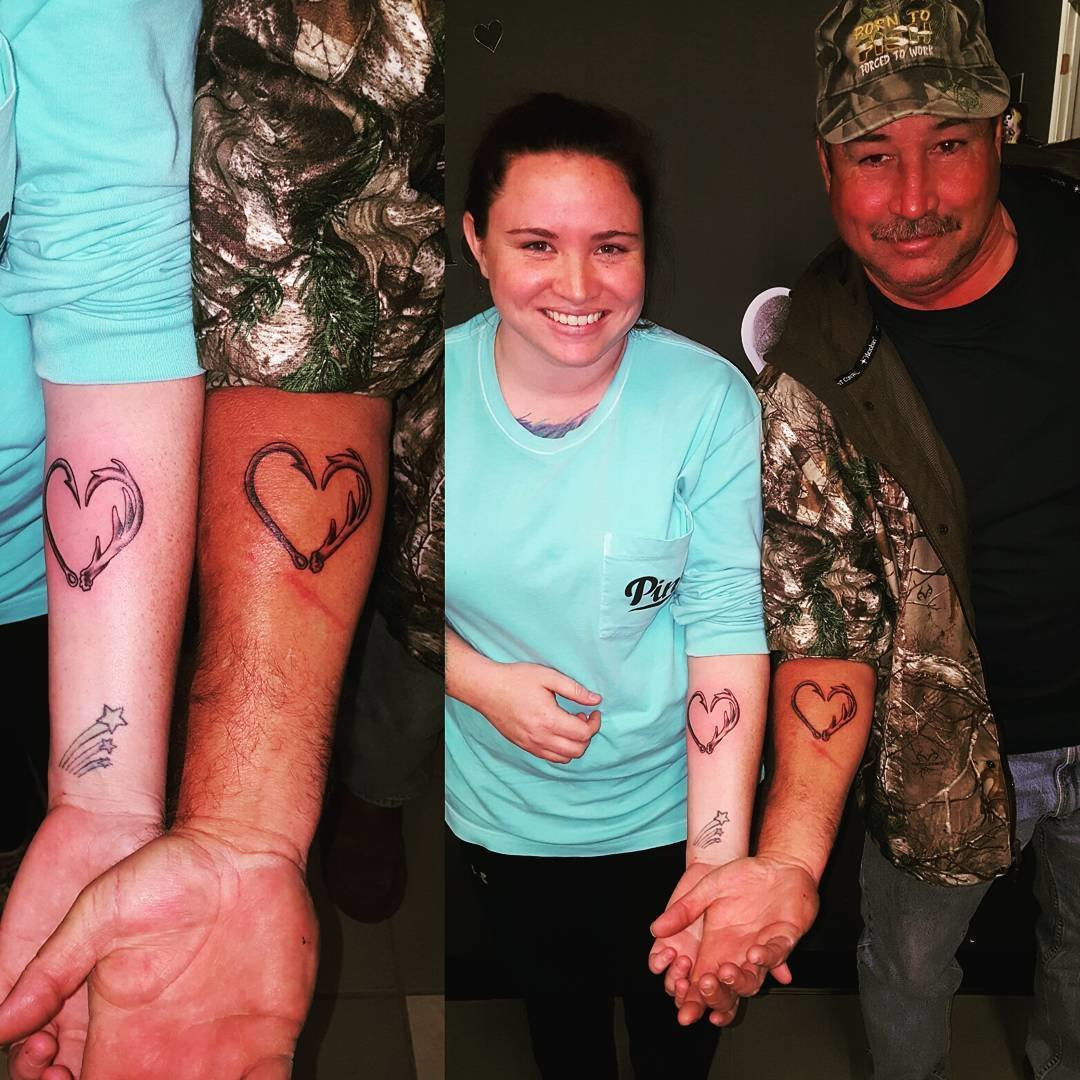 Father and daughter showcasing forearm tattoos of heart designs made of antlers, a unique twist on the classic heart symbol, blending nature and affection.