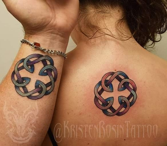 Father and daughter displaying forearm tattoos of Celtic knot designs, symbolizing their heritage and the eternal, interwoven nature of their bond.