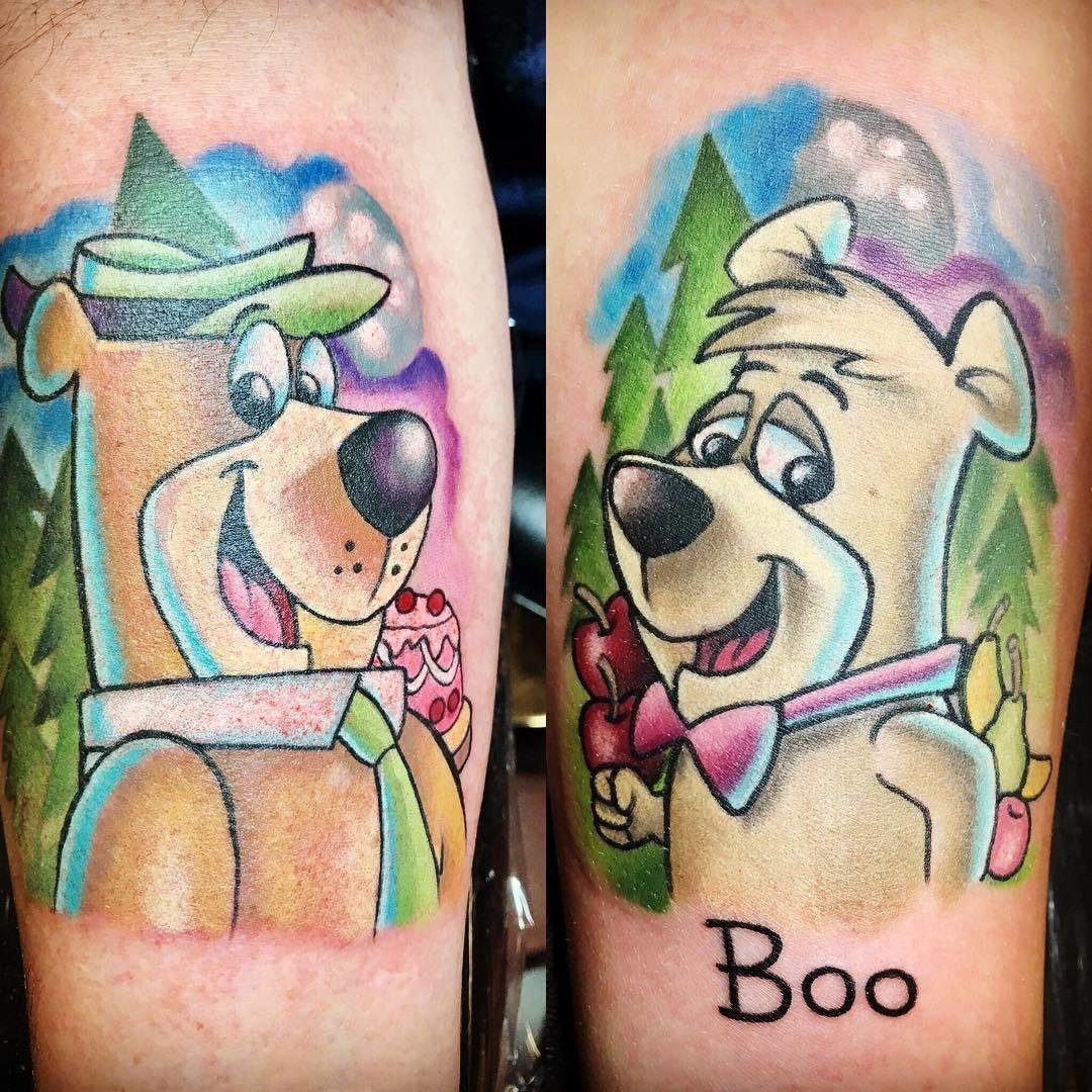 Father and daughter displaying forearm tattoos of yogi bear characters in yoga poses, a playful representation of their shared interest in yoga and mindfulness.