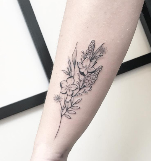 A black outline floral bouquet tattoo on a wrist.