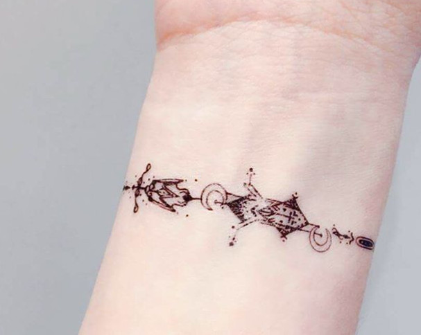 An ornate geometric tattoo design on a wrist.