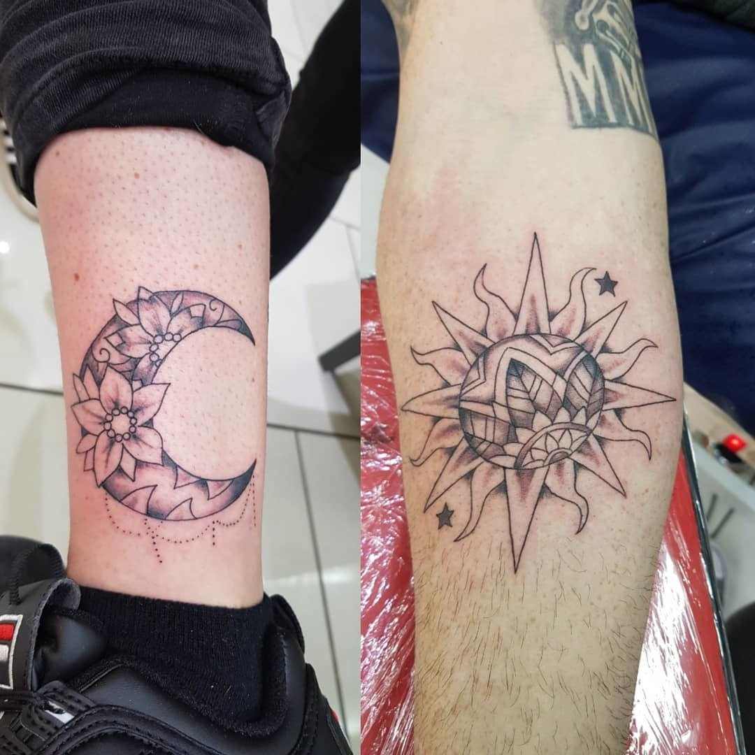 Father and daughter displaying forearm tattoos of sun and moon designs, complementary celestial bodies symbolizing balance and harmony in their relationship.