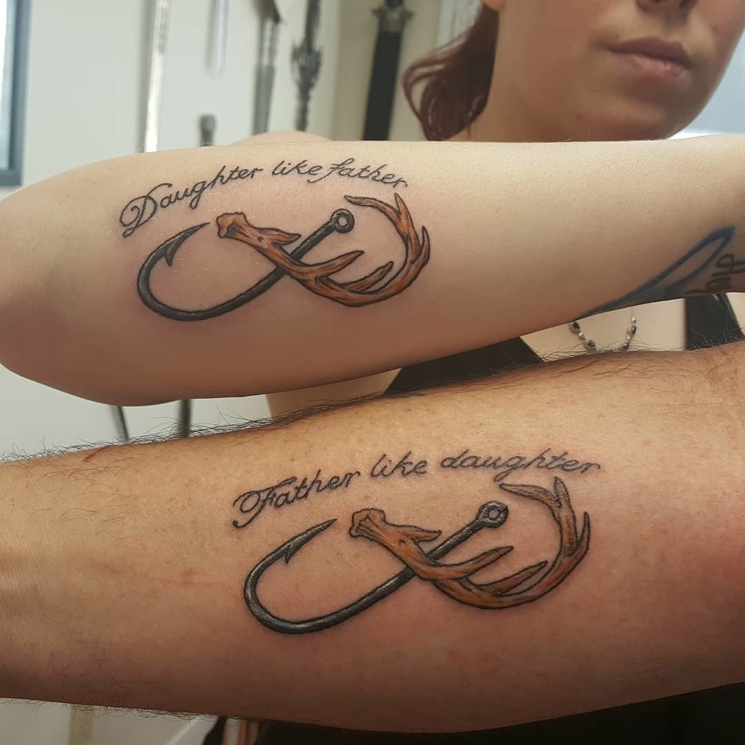 Father and daughter showcasing forearm tattoos incorporating hunting and fishing symbols like antlers and fishhooks within an infinity sign, ideal for outdoorsy duos.