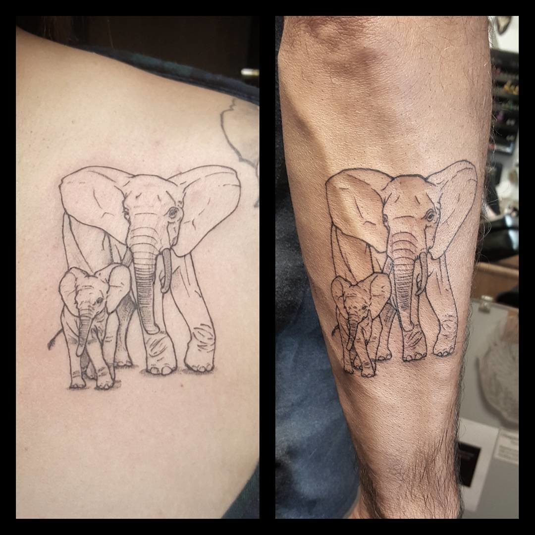 Father and daughter showcasing forearm tattoos of elephant designs, symbolizing family loyalty, protection, and the gentle strength of their bond.