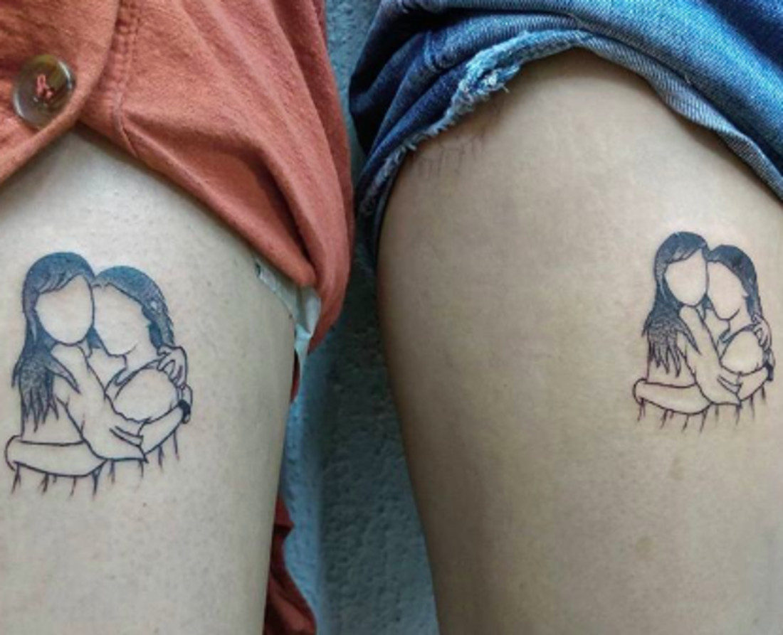 Simple line art tattoos of two figures hugging, expressing love and closeness between best friends