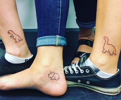 Trio of different dinosaur outline tattoos, showcasing a fun and quirky best friend group