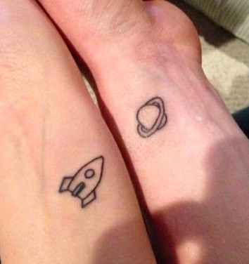 Space-themed tattoos with planets and stars, representing boundless friendship and cosmic connection