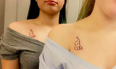 Elephant outline tattoos with trunks up, representing good luck and strong, loyal friendship