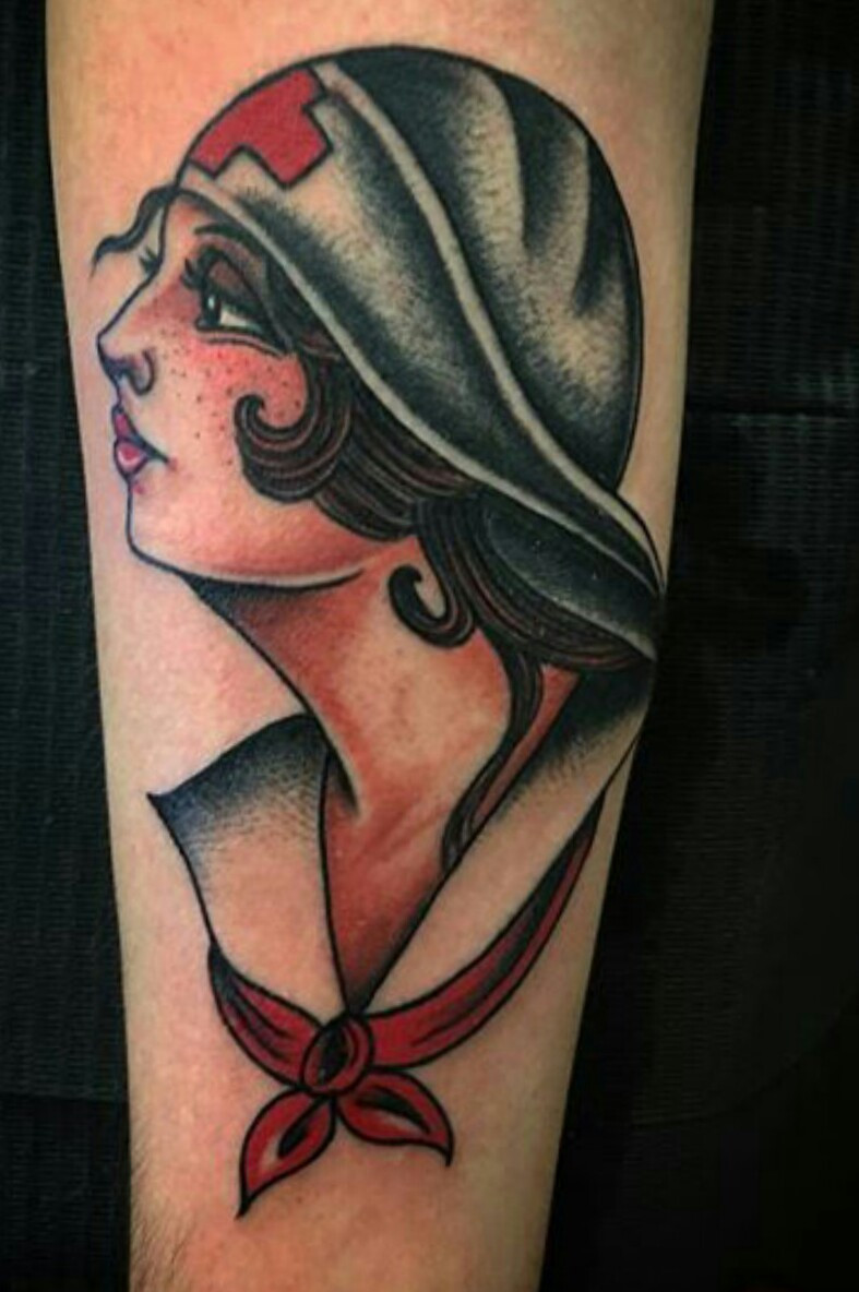 Detailed pin-up girl tattoo in black and grey.