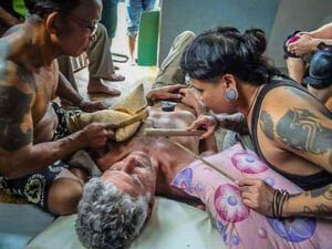 Boy Skrang focused on his craft, tattooing Anthony Bourdain with traditional techniques.