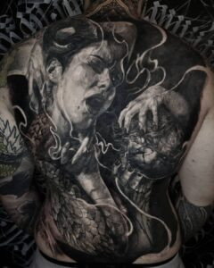 Mish in his element, focused on creating a tattoo, emphasizing trust in the artist