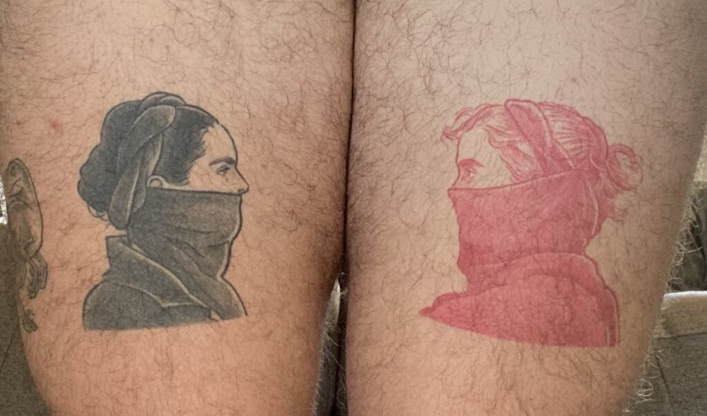 Characters from "Portrait of a Lady on Fire" tattooed on thighs, representing queer longing and film tribute.