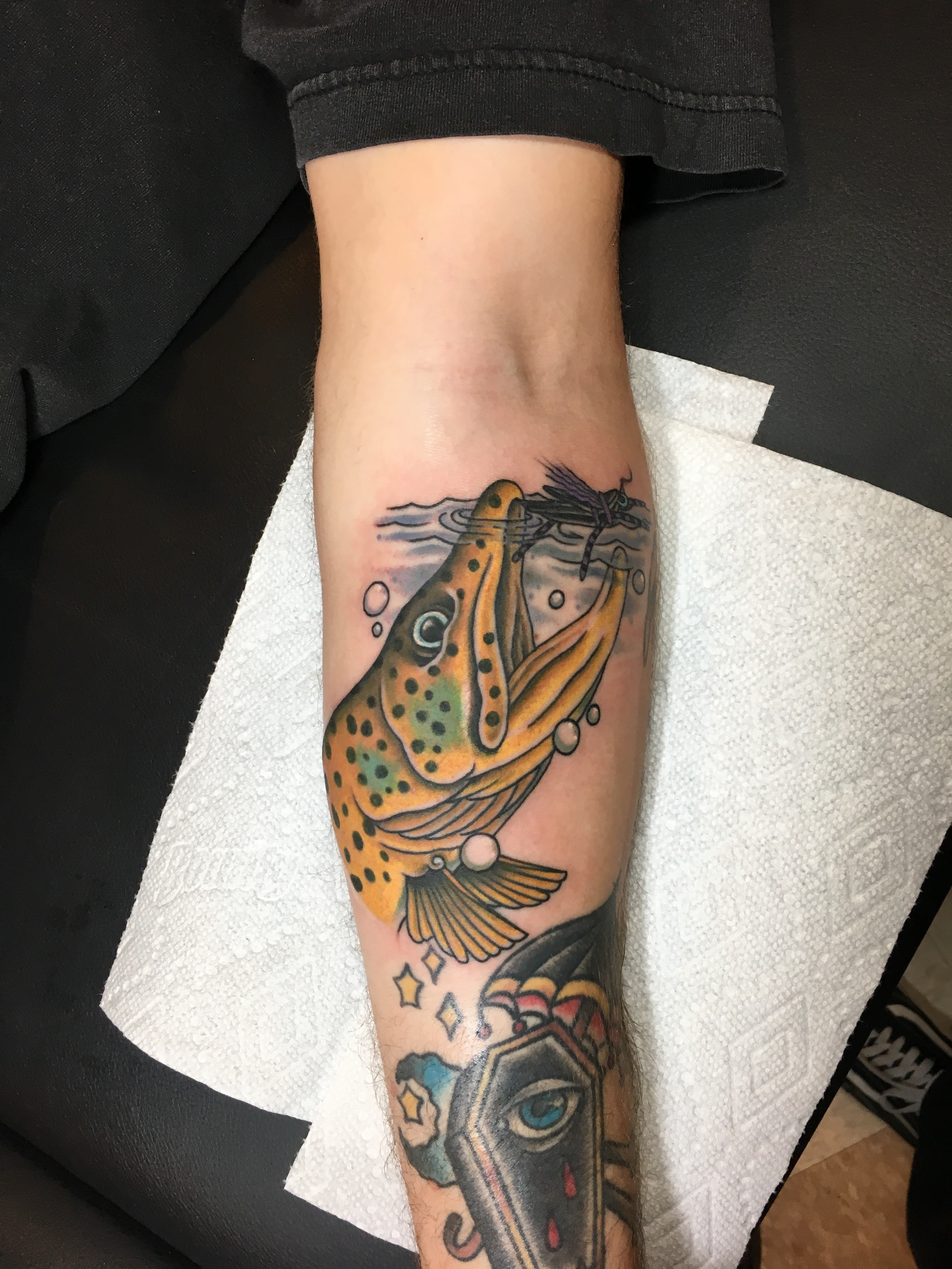 The growing trend of fish tattoos in the fly fishing community, as observed by tattoo artist Drew Wilson.