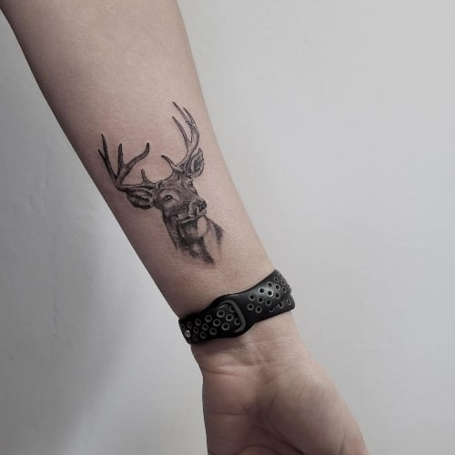 Minimalist inner wrist tattoo on a man's arm