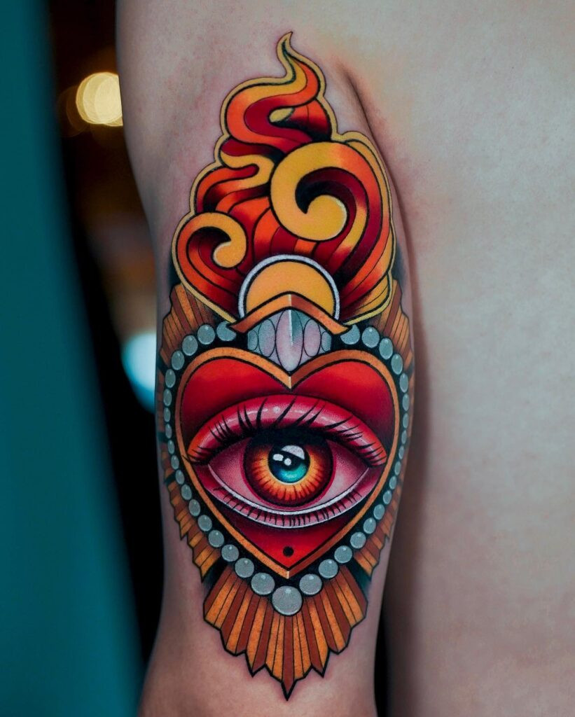 Realistic blue eye tattoo on a person's shoulder, showcasing lifelike detail and vibrant color, embodying clarity and deep perception.