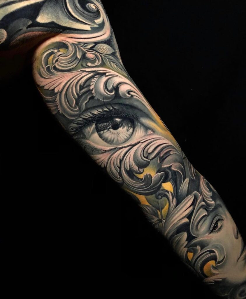 Intricate black and grey eye tattoo on an arm, showcasing detailed linework and shading, symbolizing watchfulness and inner vision.