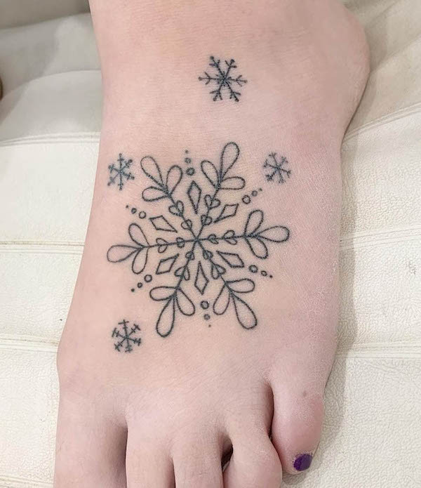 Intricate snowflake foot tattoo, showcasing the unique and detailed beauty of snowflake patterns