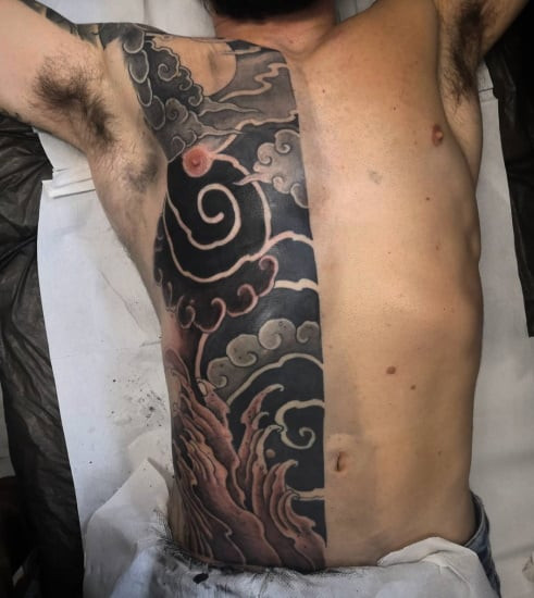 Japanese style blackwork tattoo design for men, featuring traditional motifs and bold outlines.