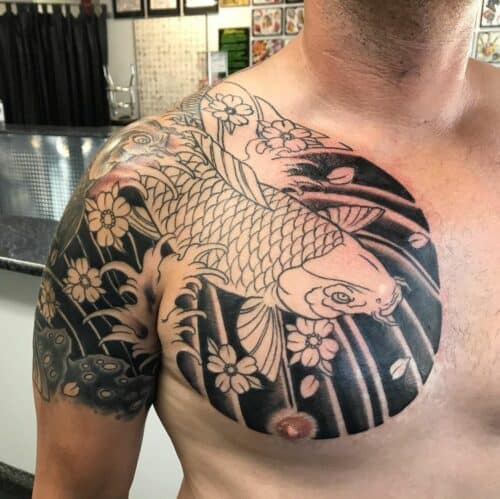 Japanese chest tattoo featuring a dragon and clouds extending from the shoulder