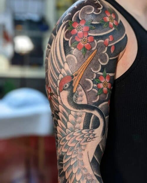 Elegant Japanese crane tattoo in flight with detailed feathers