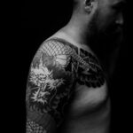 Intricate black and grey Japanese dragon tattoo on arm
