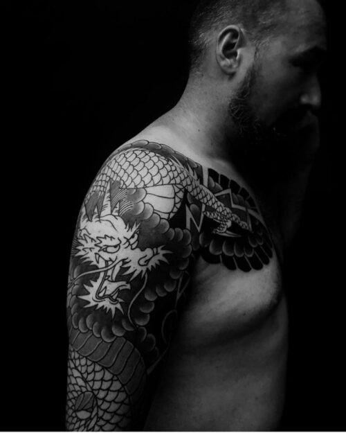 Intricate black and grey Japanese dragon tattoo on arm