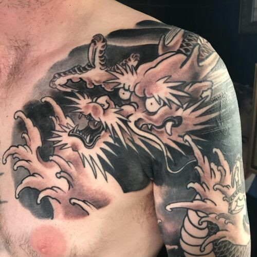 Classic traditional Japanese dragon tattoo in black and red with detailed scales