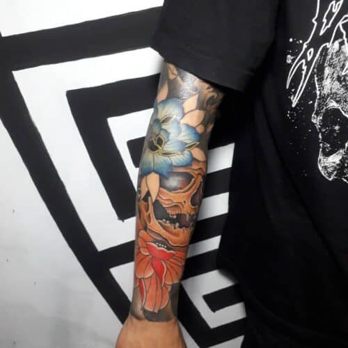 Vibrant Japanese flower tattoo featuring peonies and chrysanthemums with detailed leaves