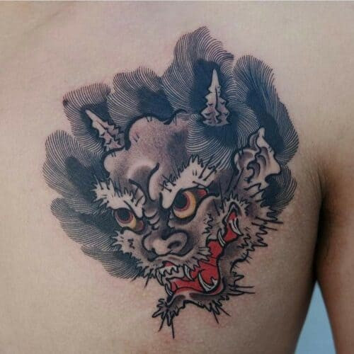 Japanese foo dog tattoo in a fierce stance with detailed fur