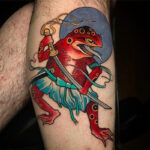 A vibrant green frog tattoo with detailed shading, showcasing traditional Japanese tattoo style.