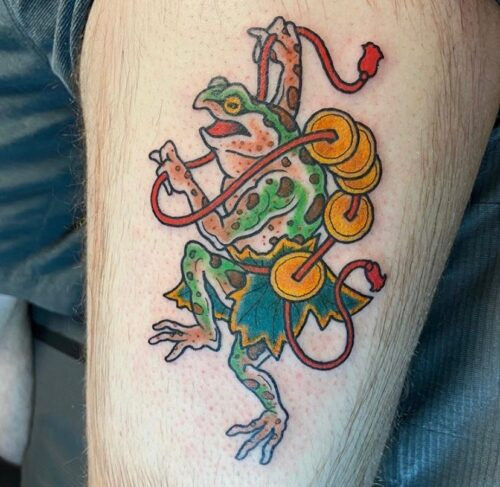Japanese frog tattoo with a golden coin and lotus flower