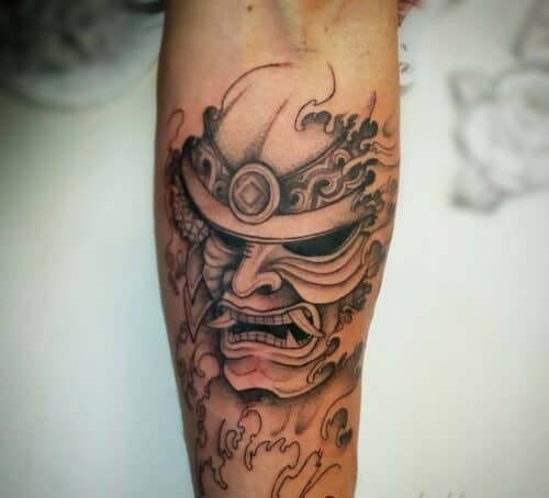 Japanese mask tattoo of a Hannya mask with fierce expression