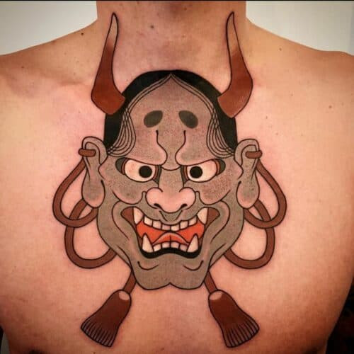 Japanese oni tattoo mask with prominent horns and sharp teeth