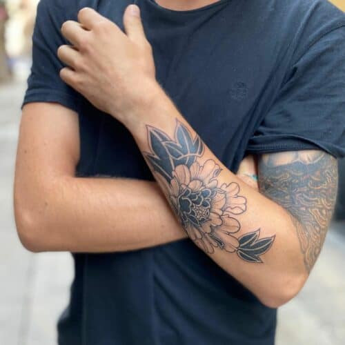 Detailed Japanese peony tattoo in pink and purple with flowing lines