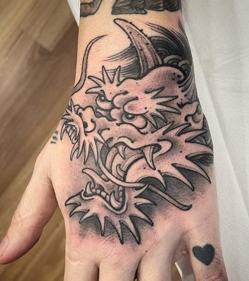 Japanese dragon and waves tattoo sleeve on a man's arm