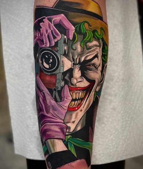 Realistic Joker portrait tattoo on a man's arm