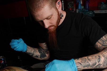 Tattoo artist Justin working at Sacred Art Tattoo 4th Ave