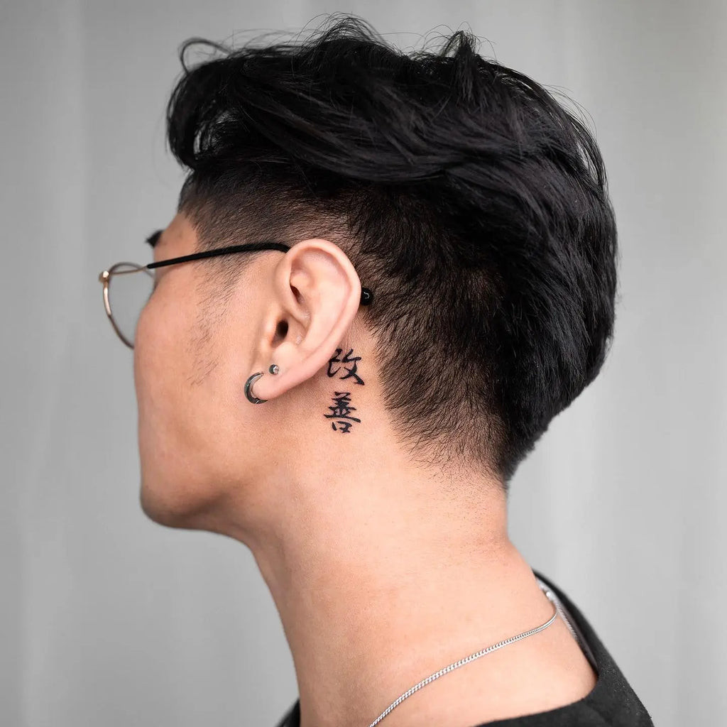 Elegant script Kaizen tattoo in a flowing, cursive font, adding a personal and artistic touch to the message of improvement