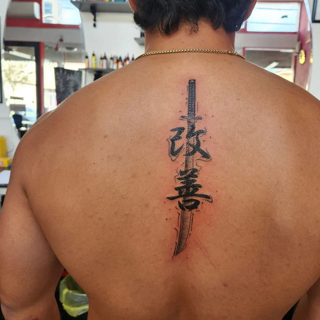 Abstract watercolor Kaizen tattoo with flowing colors and shapes, representing the fluid and evolving nature of personal growth