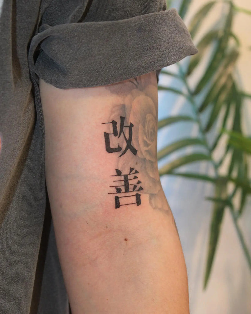 Geometric Kaizen tattoo on the arm featuring interconnected shapes representing continuous cycles of improvement