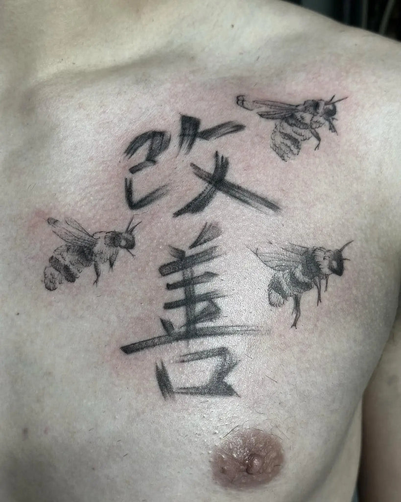 Dynamic Kaizen tattoo incorporating waves and koi fish, symbolizing perseverance and continuous flow of life's improvements