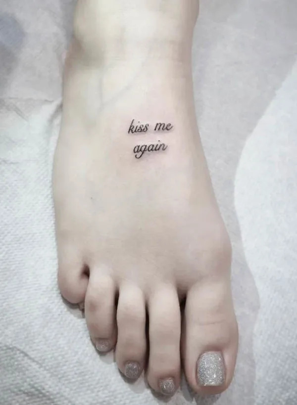 Kiss me again quote foot tattoo, a flirtatious and playful expression of affection